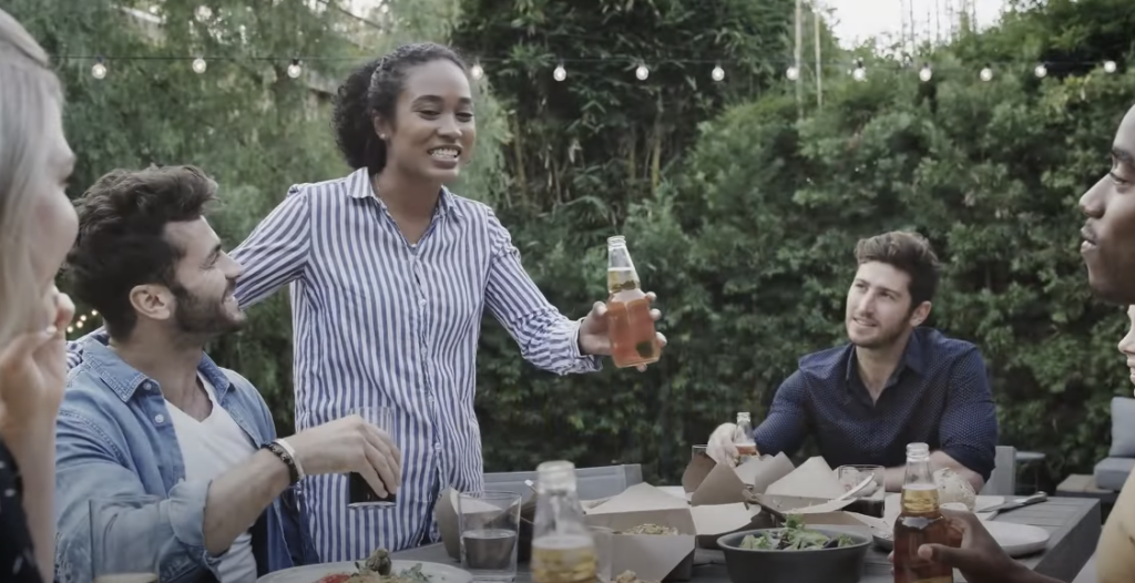 Photo of a group of friends enjoying themselves while eating and drinking