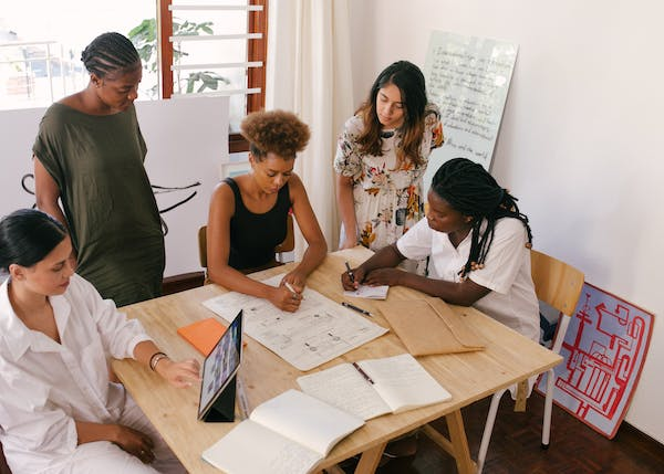 A group of diverse individuals engaging in a motivational workshop