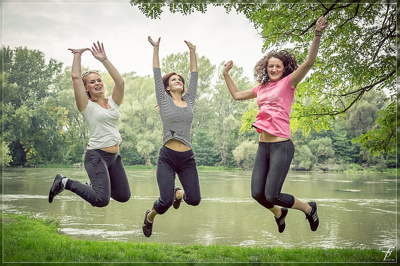 Three women jumping happily