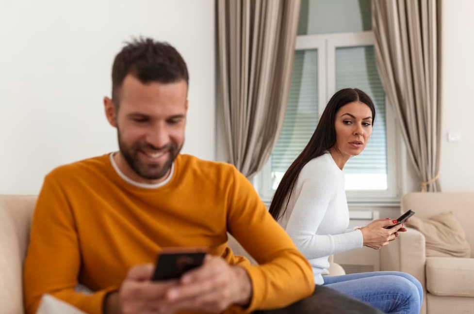 a jealous and suspicious wife watching her husband texting someone