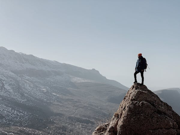 Person climbing a mountain peak" - Symbolizing personal growth