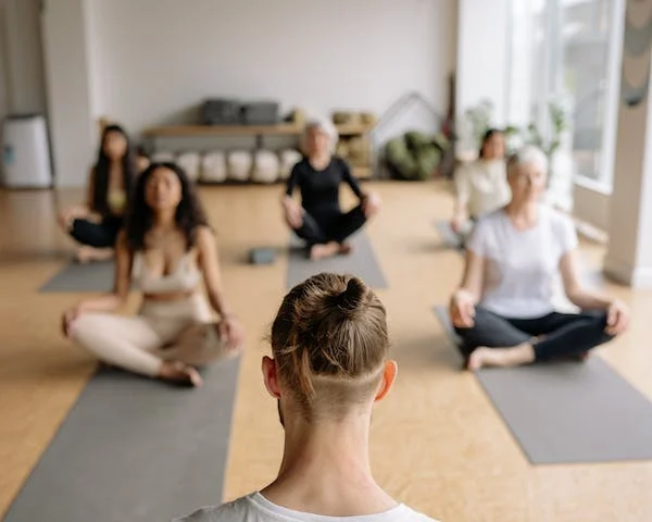 Group of people meditating on mats