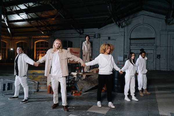 A group of diverse people holding hands, forming a human chain